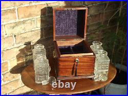 Georgian Mahogany tantalus with four cut glass decanters- lockable with handles