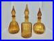 Set-Of-3-Vintage-MCM-Mini-Empoli-Amber-Ribbed-Genie-Bottle-Decanter-Withstoppers-01-gzvw