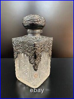 Vintage Cut glass decanter with carved silver cap