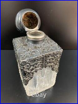 Vintage Cut glass decanter with carved silver cap