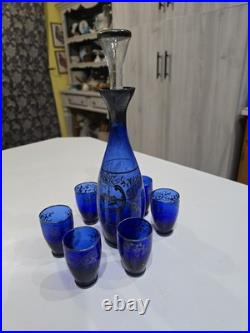 Vintage cobalt blue glass decanter and six glasses with silver overlay