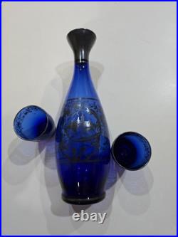 Vintage cobalt blue glass decanter and six glasses with silver overlay