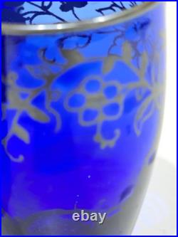 Vintage cobalt blue glass decanter and six glasses with silver overlay