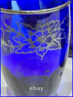 Vintage cobalt blue glass decanter and six glasses with silver overlay