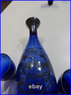 Vintage cobalt blue glass decanter and six glasses with silver overlay