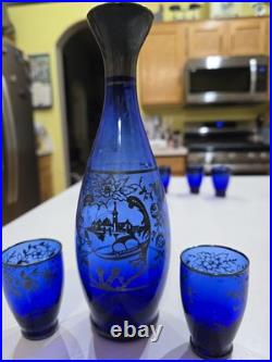 Vintage cobalt blue glass decanter and six glasses with silver overlay