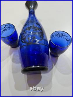 Vintage cobalt blue glass decanter and six glasses with silver overlay