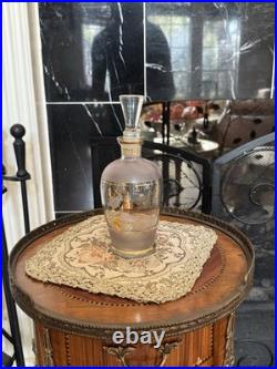 Vintage glass decanter with gold gilt detailing and a stopper
