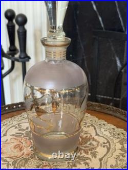 Vintage glass decanter with gold gilt detailing and a stopper
