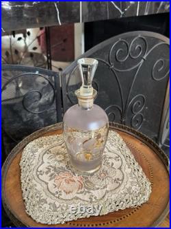 Vintage glass decanter with gold gilt detailing and a stopper