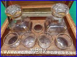 Vintage stack of books hidden liquor bar with glasses decanters. France